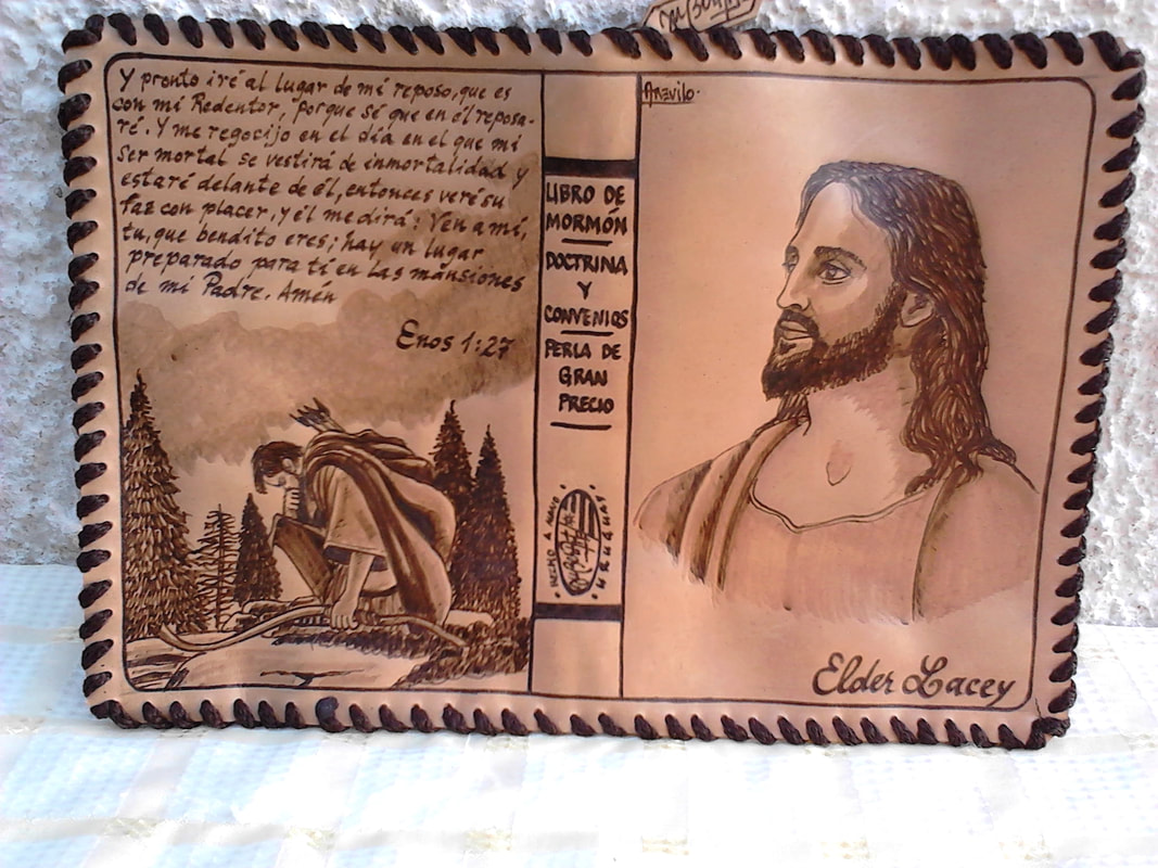 Open leather scripture cover with Spanish verse, a kneeling figure in pines, and a portrait
