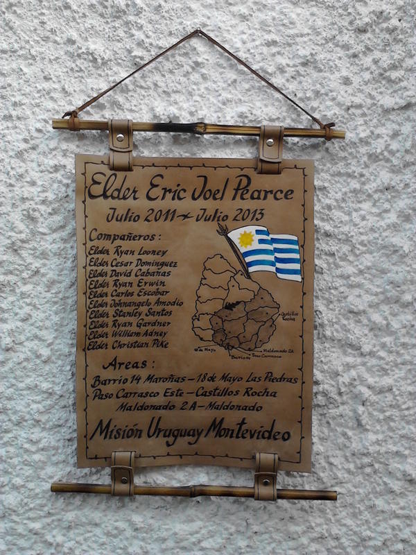 Leather hanging scroll with a map of Uruguay, the national flag, companion names, and mission dates