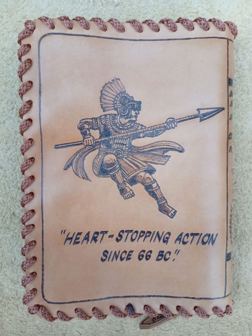 Hand-laced cowhide book cover with a Nephite warrior and spear and the line Heart-stopping action since 66 BC