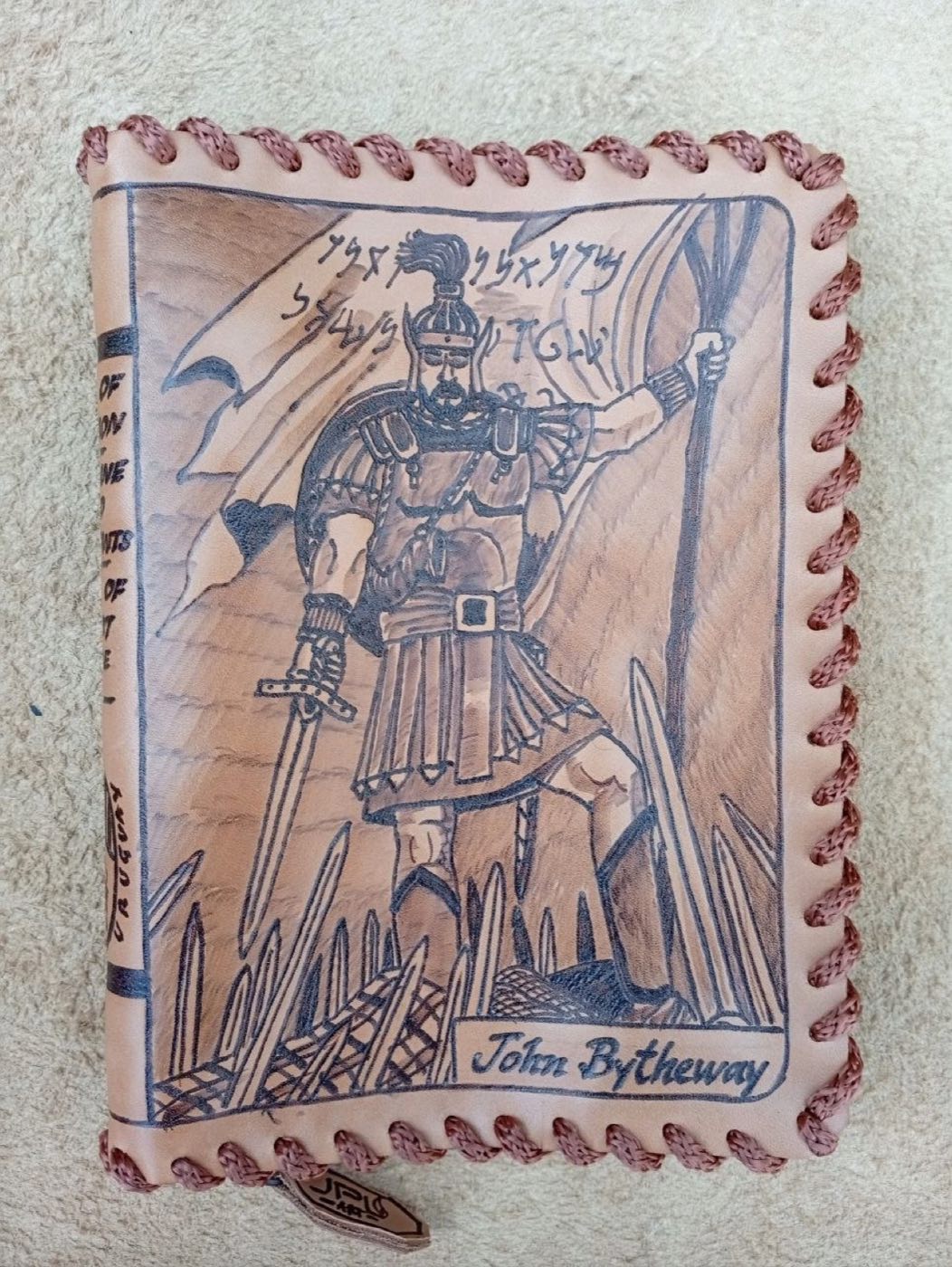 Hand-laced cowhide book cover with Captain Moroni raising the title of liberty, and the name John Bytheway