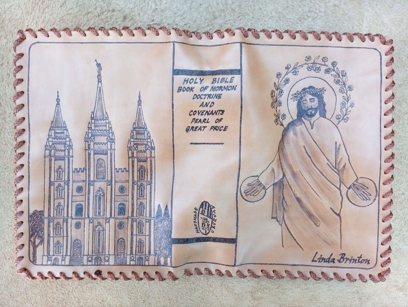 Hand-laced cowhide scripture cover with the Salt Lake Temple, Christ with a floral wreath, and the name Linda Brinton